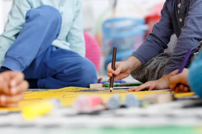 children drawing and painting at a nursery