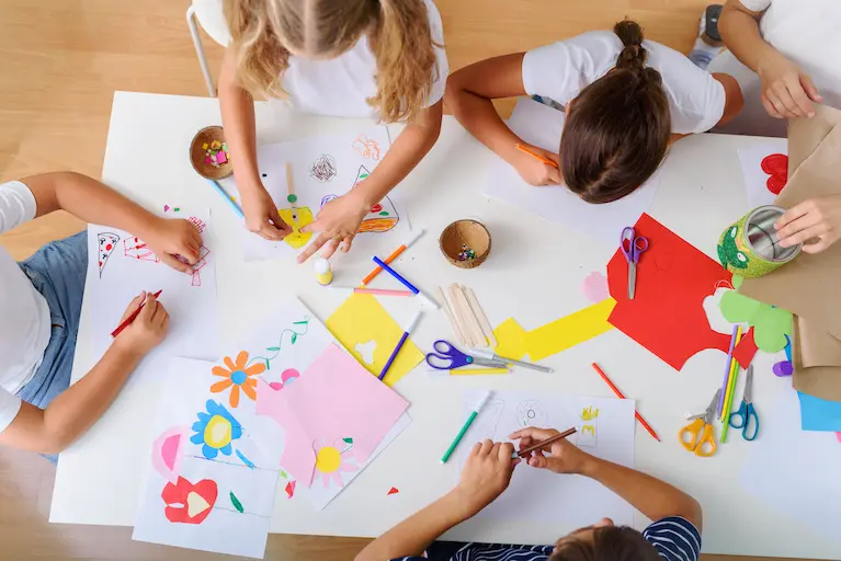 children playing and drawing at a wraparound after school club