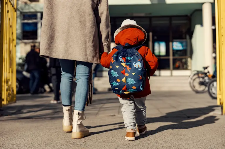 a child and parent going to preschool
