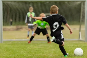 children playing football in a field
